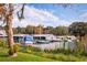 Picturesque waterfront scene with boats docked along the shoreline in a natural and tranquil setting at 1966 Wallingford Loop, Mount Dora, FL 32757