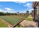 Outdoor bocce ball courts with seating and shade structures provide recreational enjoyment in a landscaped setting at 1966 Wallingford Loop, Mount Dora, FL 32757