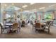 A card and game room featuring multiple round tables and comfortable chairs, perfect for friendly gatherings at 1966 Wallingford Loop, Mount Dora, FL 32757