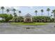 The clubhouse entrance features stately palm trees and a circular driveway leading to the elegant main building at 1966 Wallingford Loop, Mount Dora, FL 32757