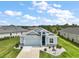 Charming single-story home with a well-manicured lawn, featuring a two-car garage and welcoming front entrance at 1966 Wallingford Loop, Mount Dora, FL 32757