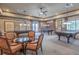 Spacious game room featuring multiple billiards tables and seating area for entertaining guests and residents at 1966 Wallingford Loop, Mount Dora, FL 32757