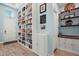 Open hallway featuring built-in bookshelves and access to a bar area at 1966 Wallingford Loop, Mount Dora, FL 32757