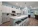 Open kitchen featuring an island with bar stool seating, stainless steel appliances, and modern finishes at 1966 Wallingford Loop, Mount Dora, FL 32757