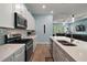 Well-equipped kitchen boasting stainless steel appliances, stylish backsplash, and a seamless flow to the living area at 1966 Wallingford Loop, Mount Dora, FL 32757