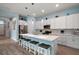 Modern kitchen with stainless steel appliances, quartz countertops, and pendant lighting over the island at 1966 Wallingford Loop, Mount Dora, FL 32757