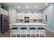 Bright kitchen featuring a large island with bar stool seating, stainless appliances, and modern finishes at 1966 Wallingford Loop, Mount Dora, FL 32757