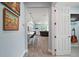 Hallway view into a cozy living room with bar seating and a comfortable seating area at 1966 Wallingford Loop, Mount Dora, FL 32757