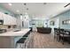 Bright, open-concept living area with modern kitchen, dining space, and comfortable seating at 1966 Wallingford Loop, Mount Dora, FL 32757