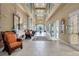 An expansive lobby area with tiled floors and columns provides ample seating areas and natural light at 1966 Wallingford Loop, Mount Dora, FL 32757