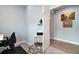 Office area with a desk, printer, shelving, and view into the hallway at 1966 Wallingford Loop, Mount Dora, FL 32757
