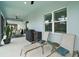 Relaxing screened-in patio with comfortable lounge chairs and dining furniture for outdoor enjoyment at 1966 Wallingford Loop, Mount Dora, FL 32757