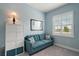Sitting room with a blue couch, window, and shelving for storage at 1966 Wallingford Loop, Mount Dora, FL 32757