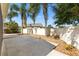 Backyard with paved patio, rock landscaping, and white privacy fence at 2042 Hydrangea Ave, The Villages, FL 32162