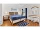 Cozy bedroom with wood floors, ceiling fan, and abundant natural light at 2042 Hydrangea Ave, The Villages, FL 32162