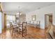 A dining and seating area flows into an open floor plan that also leads to a bathroom at 2042 Hydrangea Ave, The Villages, FL 32162