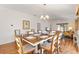 The dining area provides a beautiful table setting with a view into the living room at 2042 Hydrangea Ave, The Villages, FL 32162