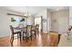 Dining area featuring hardwood floors, a stylish table, and chairs, next to the front entry of the home at 2042 Hydrangea Ave, The Villages, FL 32162