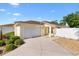 Charming single-story home with a well-maintained lawn, inviting front entrance, and two car garage at 2042 Hydrangea Ave, The Villages, FL 32162