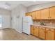 The kitchen shows plenty of cabinet space and a full sized refrigerator next to the front entry way at 2042 Hydrangea Ave, The Villages, FL 32162