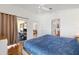 Spacious main bedroom with wood floors, ceiling fan, and ensuite bathroom at 2042 Hydrangea Ave, The Villages, FL 32162