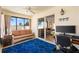 Sunroom featuring a geometric blue rug, comfortable striped couch, and ample natural light through sliding glass doors at 2042 Hydrangea Ave, The Villages, FL 32162