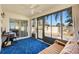 Bright sunroom with large windows, blue rug, ceiling fan, and comfortable seating, creating a cozy and inviting space at 2042 Hydrangea Ave, The Villages, FL 32162