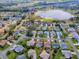 An aerial view of a neighborhood showcasing a home near a lake and golf course at 2103 Patino Ln, The Villages, FL 32159