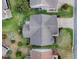 Aerial view of a house showing its roof, landscaping, driveway, and surrounding neighborhood at 2103 Patino Ln, The Villages, FL 32159