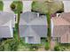 Aerial view showcasing a home's roof, driveway, and landscaping within a residential neighborhood at 2103 Patino Ln, The Villages, FL 32159