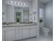 Bathroom with white vanity, granite countertops, framed mirror, and decor at 2103 Patino Ln, The Villages, FL 32159