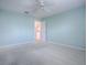 This bedroom features neutral paint, a ceiling fan, carpet, and access to the bathroom at 2103 Patino Ln, The Villages, FL 32159