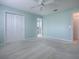 This bedroom features neutral paint, a ceiling fan, carpet, and a closet with sliding doors at 2103 Patino Ln, The Villages, FL 32159