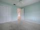 Bedroom with neutral carpeting and walls, plus a closet and doorway at 2103 Patino Ln, The Villages, FL 32159
