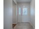 Front entry featuring a beautiful glass-paneled door with decorative detailing and tile flooring at 2103 Patino Ln, The Villages, FL 32159
