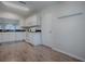 White kitchen features modern appliances, ample cabinet space, and a practical layout at 2103 Patino Ln, The Villages, FL 32159