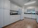 A modern kitchen offers sleek countertops and cabinetry, perfect for culinary enthusiasts at 2103 Patino Ln, The Villages, FL 32159
