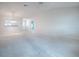 Spacious living area with open layout and kitchen pass through with modern pendant lighting at 2103 Patino Ln, The Villages, FL 32159