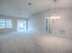 Open concept living room featuring high ceilings, ceiling fan, and sunroom access for ample natural light at 2103 Patino Ln, The Villages, FL 32159