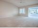 Bright, spacious living room with high ceilings and access to a sunroom with ample natural light at 2103 Patino Ln, The Villages, FL 32159