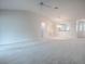 Open living space with vaulted ceiling, ceiling fan, and view of kitchen passthrough at 2103 Patino Ln, The Villages, FL 32159