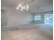 Bright and spacious living room with high ceilings and an adjacent sunroom, perfect for relaxation at 2103 Patino Ln, The Villages, FL 32159
