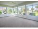 Bright sunroom with neutral carpet, lots of windows, and white trim at 2103 Patino Ln, The Villages, FL 32159
