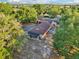 An aerial view showcasing the home's extended roofline and backyard, surrounded by mature trees at 23519 State Road 44, Eustis, FL 32736