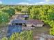 Scenic aerial view of a home with a long driveway, surrounded by lush greenery and a large yard at 23519 State Road 44, Eustis, FL 32736