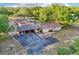 Aerial view showcasing the house with a carport, an extended driveway, and landscaped yard at 23519 State Road 44, Eustis, FL 32736