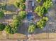 Overhead shot of a well-maintained property with mature trees, a long driveway, and a quaint home at 23519 State Road 44, Eustis, FL 32736