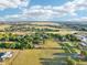 Expansive aerial view showcases the property's green space, nearby community, golf course, and beautiful blue sky at 23519 State Road 44, Eustis, FL 32736