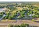 Wide aerial shot showcasing the property with beautiful landscape, trees, and surrounding neighborhood at 23519 State Road 44, Eustis, FL 32736