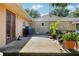 Cozy backyard patio area featuring a grill, planters, and a view of the home's architecture at 23519 State Road 44, Eustis, FL 32736